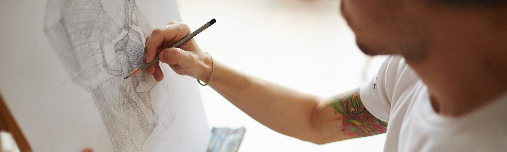 A person drawing with a pencil