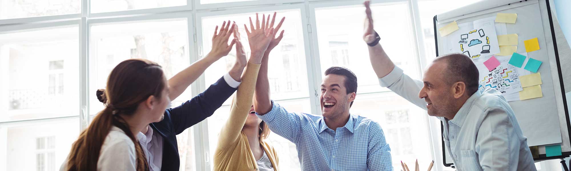 Four people in an office as a team