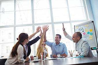 Four people in an office as a team