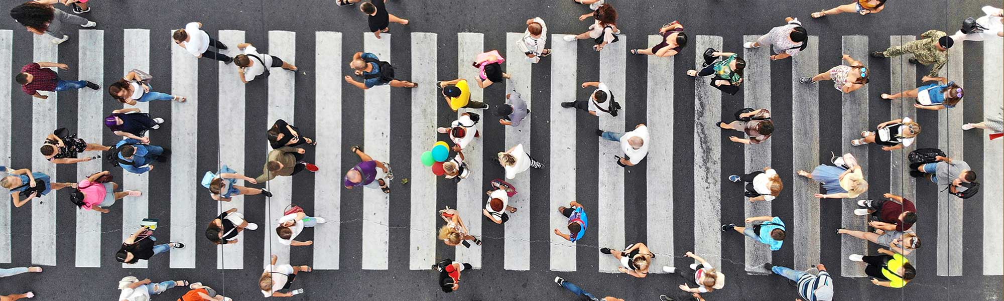 People walking across a zebra crossing