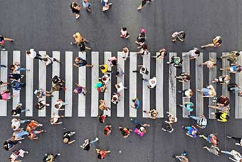 People walking across a zebra crossing